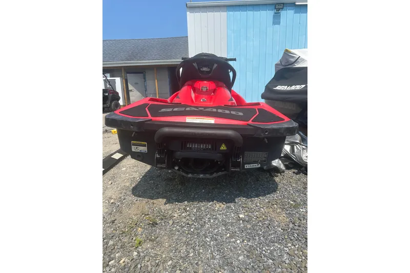 The Image of 2012 Sea-Doo GTI SE jet ski, red and black, parked outdoors. - 1