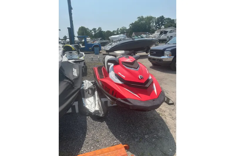 Slide: The Image of Red 2012 Sea-Doo GTI SE jet ski parked outdoors on gravel. - 3