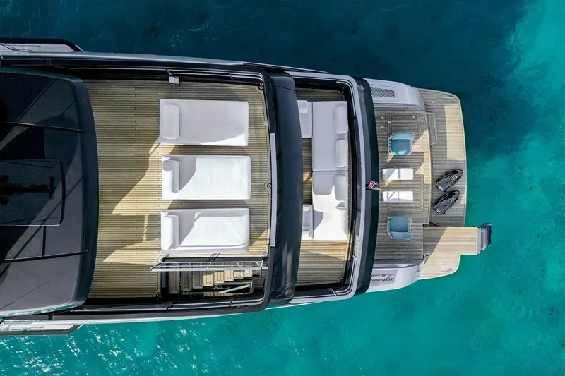 Slide: The Image of Aerial view of 2023 Riva 130' Bellissima yacht with sun loungers and turquoise water. - 23