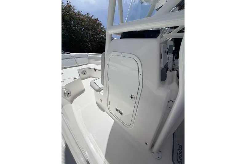 Slide: The Image of 2020 Sea Fox 249 Avenger boat interior with white seating and storage compartment. - 15