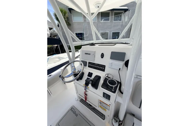 Slide: The Image of 2020 Sea Fox 249 Avenger boat console with steering wheel and Simrad electronics. - 25