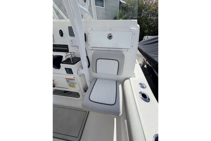 Slide: The Image of 2020 Sea Fox 249 Avenger boat interior with white seating and control panel. - 23