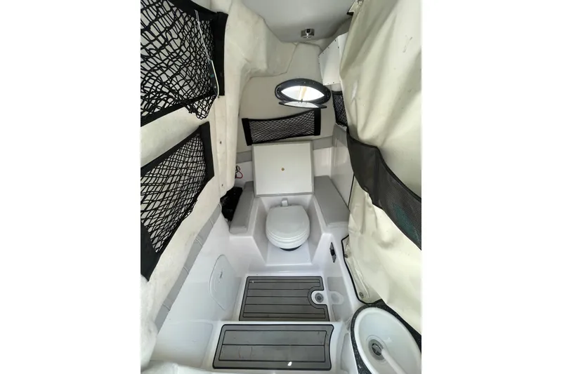 Slide: The Image of Interior of 2020 Sea Fox 249 Avenger boat featuring a compact marine toilet. - 18