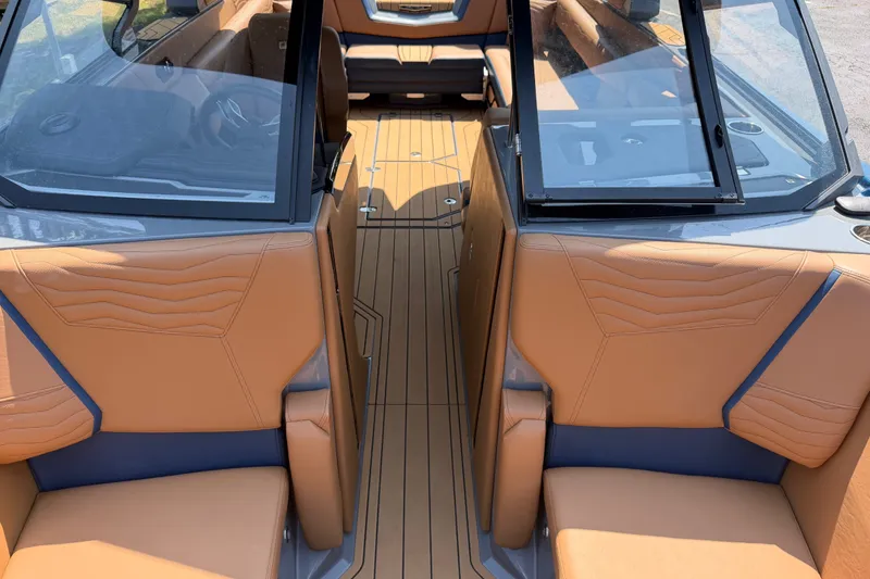 Slide: The Image of 2026 Nautique Super Air Nautique G25 interior with tan leather seating and sleek design. - 19