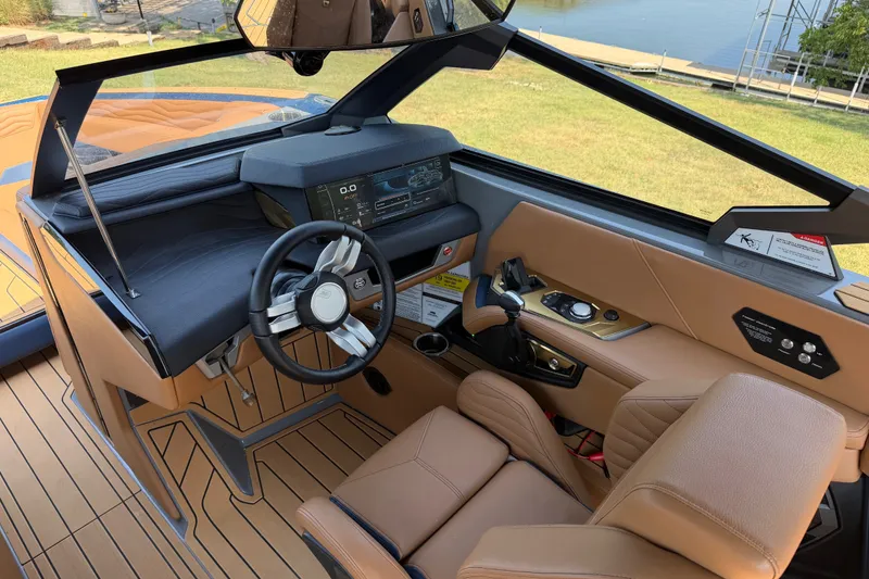 Slide: The Image of Interior of 2026 Nautique Super Air Nautique G25 boat, featuring modern dashboard and steering wheel. - 15