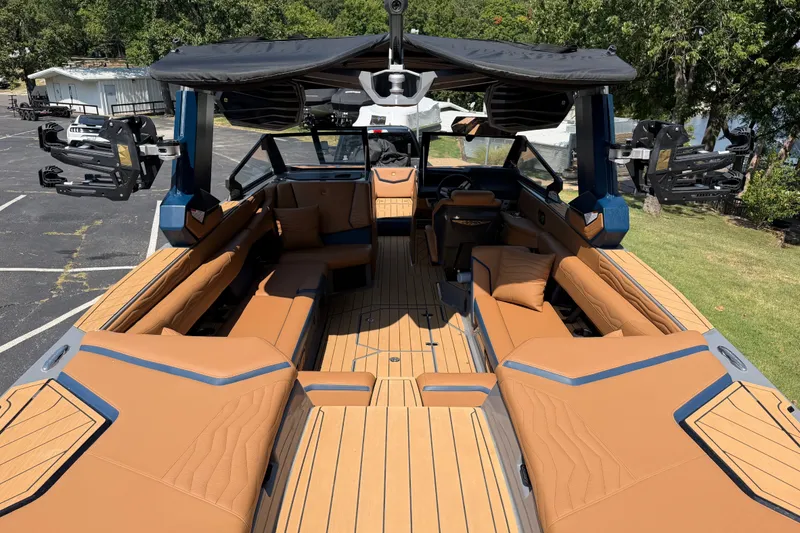 Slide: The Image of 2026 Nautique Super Air Nautique G25 boat interior with tan seating and sleek design. - 12