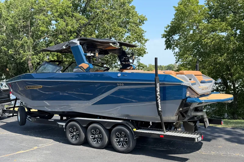 Slide: The Image of 2026 Nautique Super Air Nautique G25 boat on trailer, parked outdoors. - 4