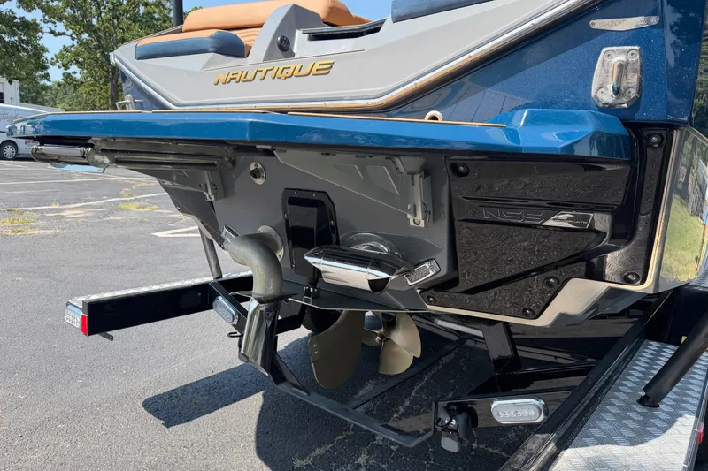 Slide: The Image of 2026 Nautique Super Air Nautique G25 boat rear view, showcasing propeller and NSS system. - 8
