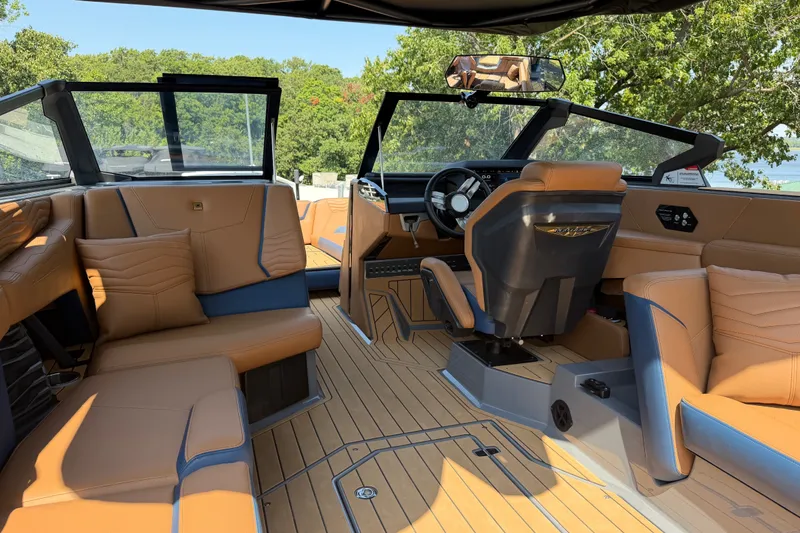 Slide: The Image of Interior of 2026 Nautique Super Air Nautique G25 with luxurious seating and modern dashboard. - 24