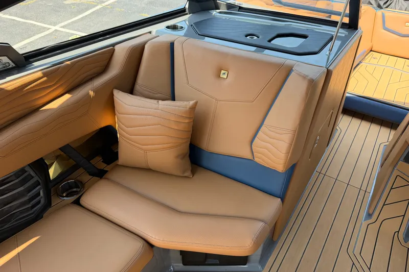 Slide: The Image of Luxurious interior of 2026 Nautique Super Air Nautique G25 with tan leather seating. - 17