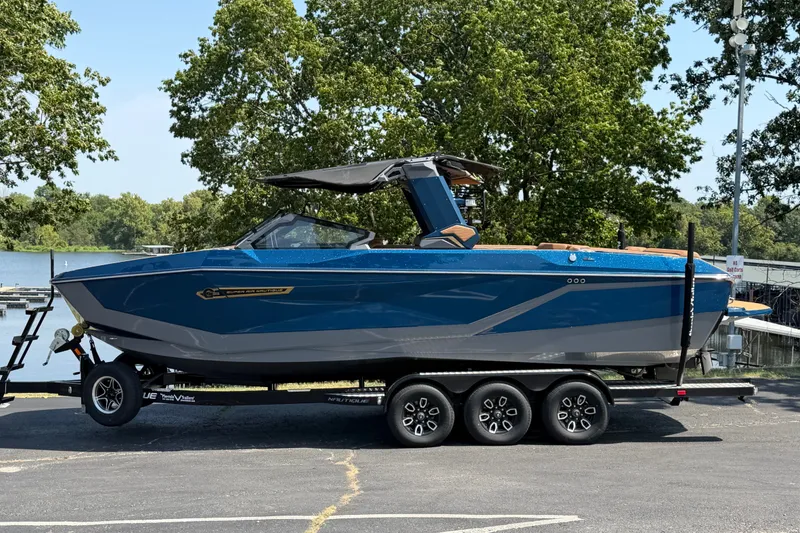 Slide: The Image of 2026 Nautique Super Air Nautique G25 boat on trailer by lakeside. - 6
