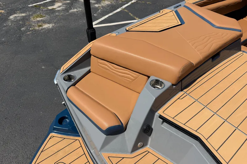 Slide: The Image of 2026 Nautique Super Air Nautique G25 boat with tan seating and teak flooring. - 11