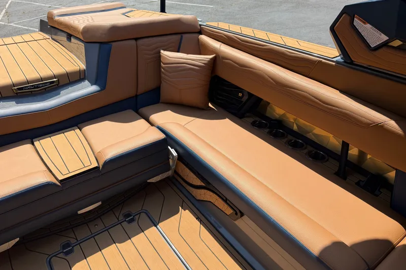Slide: The Image of Luxurious interior of 2026 Nautique Super Air Nautique G25 boat with tan leather seating. - 18