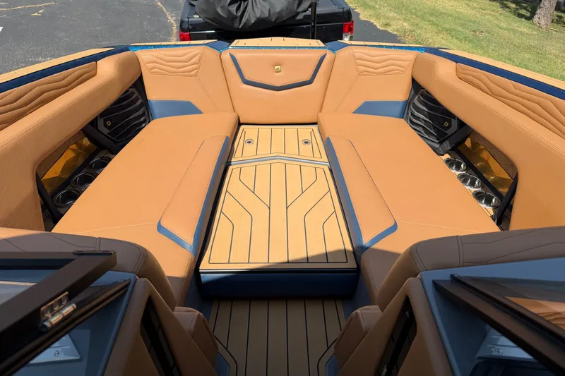 Slide: The Image of Luxurious interior of 2026 Nautique Super Air Nautique G25 boat with tan seating. - 14