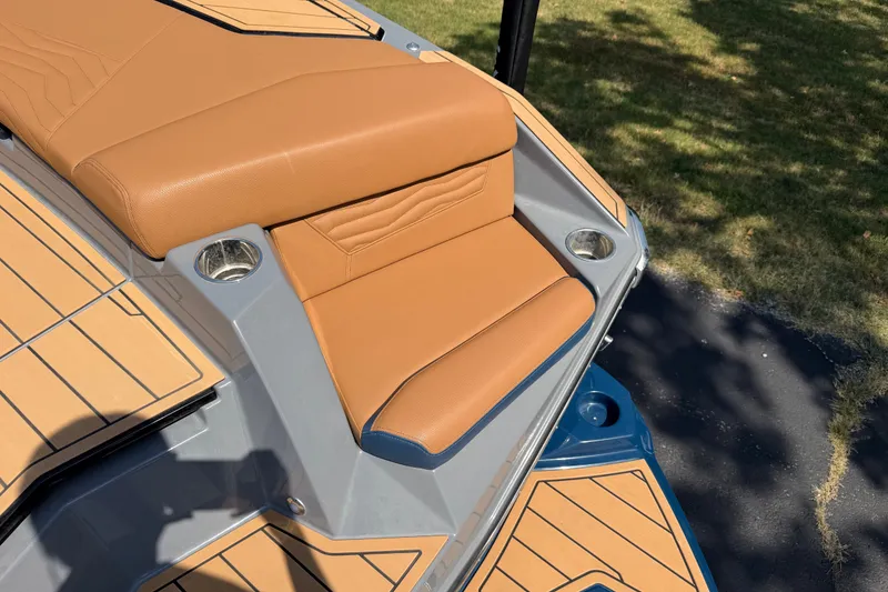 Slide: The Image of 2026 Nautique Super Air Nautique G25 boat with tan seating and cup holders. - 10