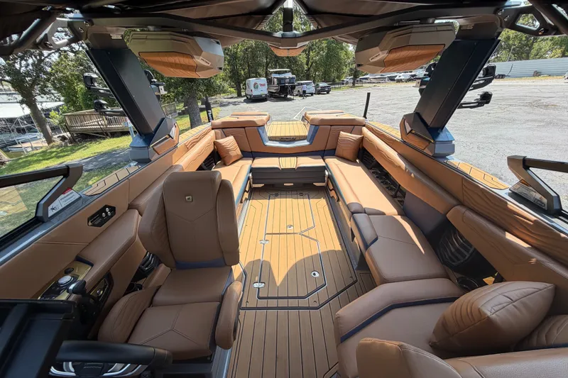 Slide: The Image of Luxurious interior of 2026 Nautique Super Air Nautique G25 boat with tan leather seating. - 22