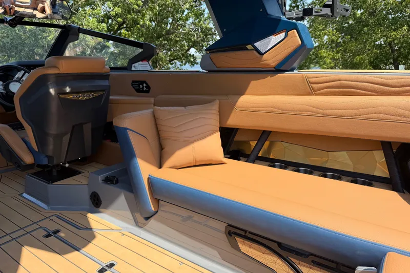 Slide: The Image of Luxurious interior of 2026 Nautique Super Air Nautique G25 boat with tan seating. - 23