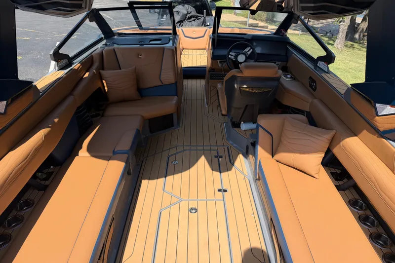 Slide: The Image of Luxurious interior of 2026 Nautique Super Air Nautique G25 boat with tan seating. - 13
