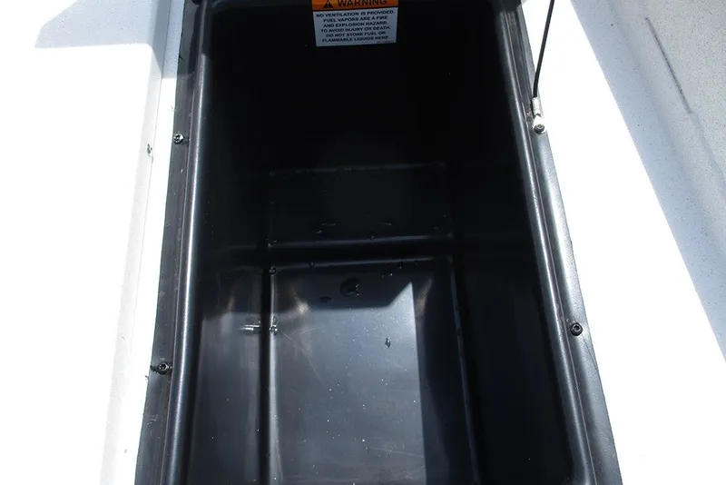 Slide: The Image of Open storage compartment in 2026 G3 Bay 17 boat, featuring a warning label. - 15