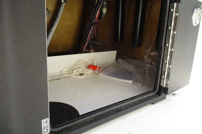 Slide: The Image of Open storage compartment in G3 Bay 17 boat, showing wiring and accessories, 2026 model. - 23