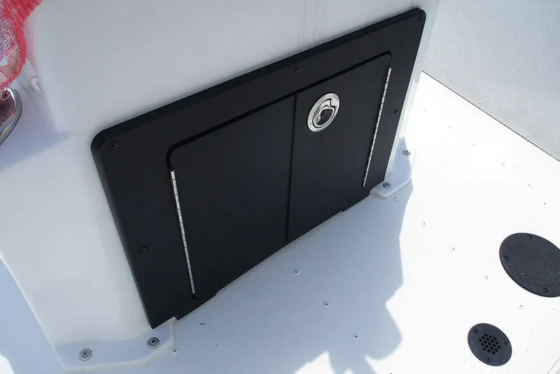 Slide: The Image of 2026 G3 Bay 17 boat storage compartment with black door and latch. - 21