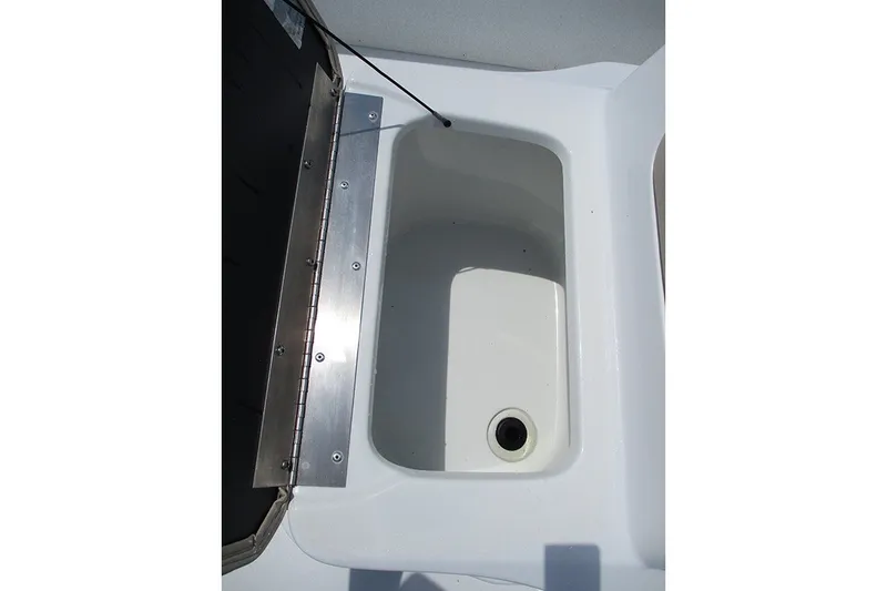 Slide: The Image of Open storage compartment on 2026 G3 Bay 17 boat, featuring a drain plug. - 20