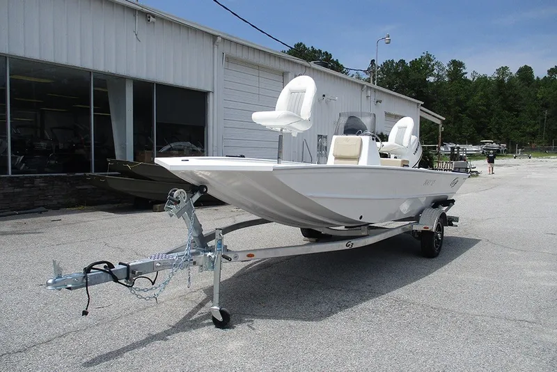 Slide: The Image of 2026 G3 Bay 17 boat on trailer outside a showroom. - 3