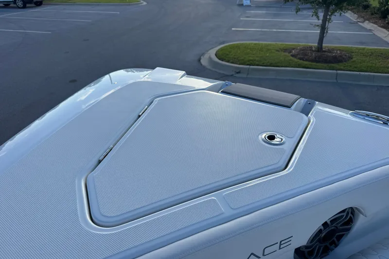 Slide: The Image of 2027 Solace 28HCS boat deck with sleek design and storage compartment. - 27