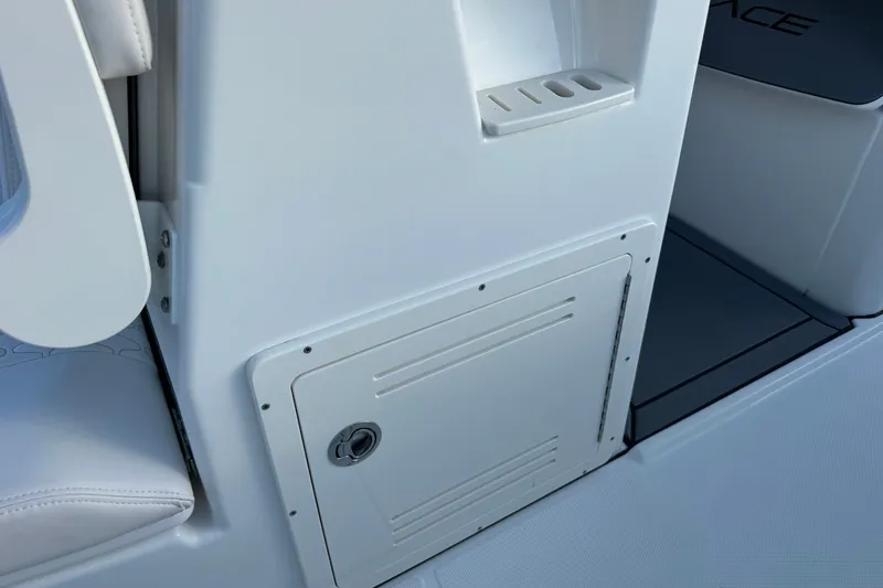 Slide: The Image of Interior detail of 2027 Solace 28HCS boat, featuring storage compartment and seating. - 22