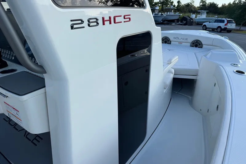 Slide: The Image of 2027 Solace 28HCS boat interior with seating and console details. - 24