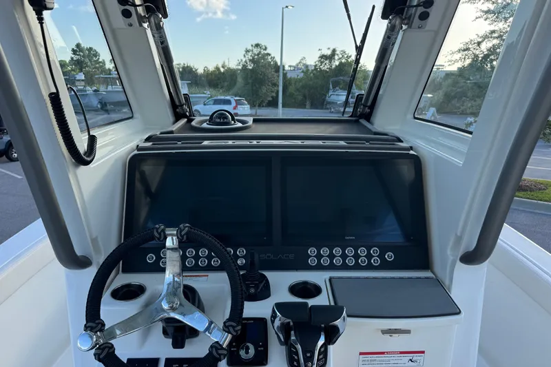 Slide: The Image of Helm of 2027 Solace 28HCS boat with dual screens and steering wheel. - 20