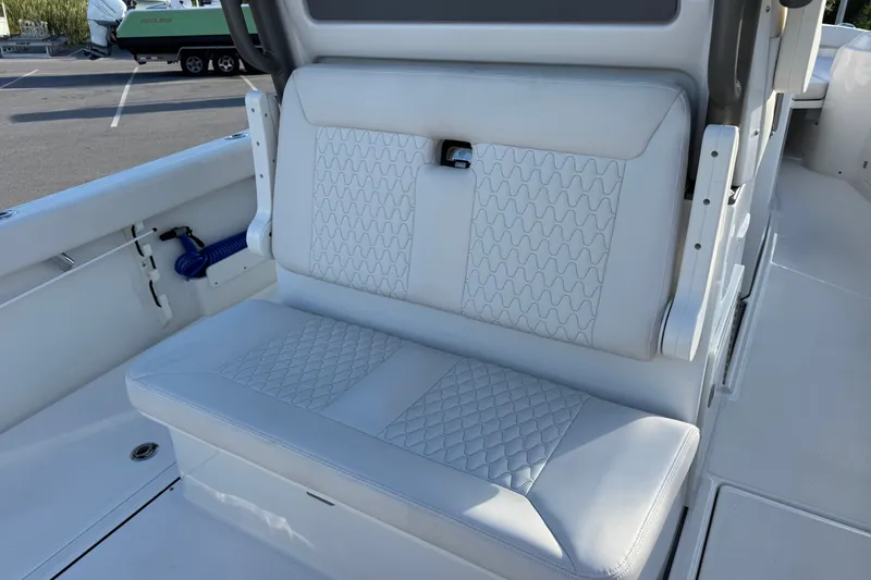 Slide: The Image of 2027 Solace 28HCS boat interior with white cushioned seating. - 14