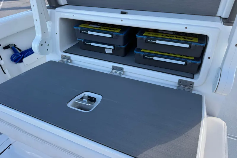 Slide: The Image of Storage compartment with tackle boxes on a 2027 Solace 28HCS boat. - 15