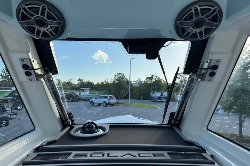 Slide: The Image of Interior view of 2027 Solace 28HCS boat, showcasing windshield and speakers. - 21
