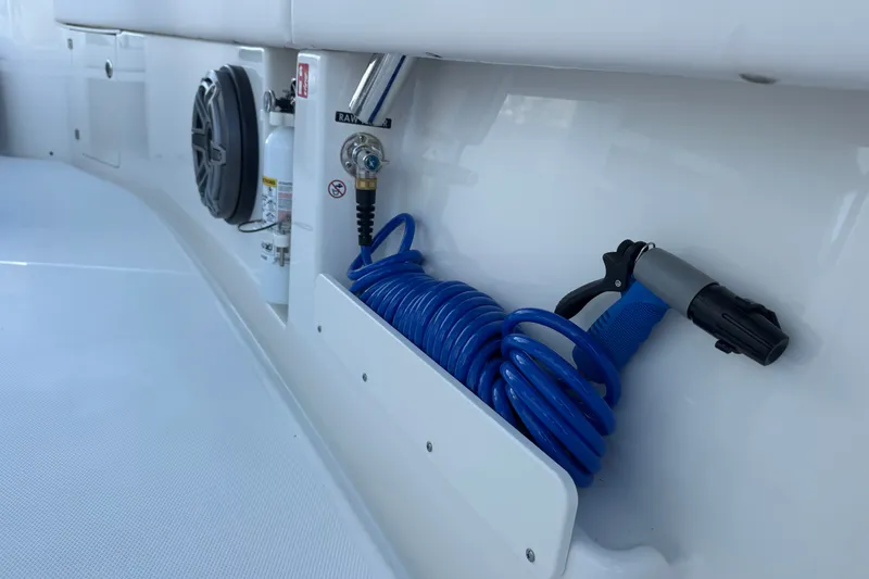 Slide: The Image of Coiled blue hose and fire extinguisher on Solace 28HCS boat, 2027 model. - 23