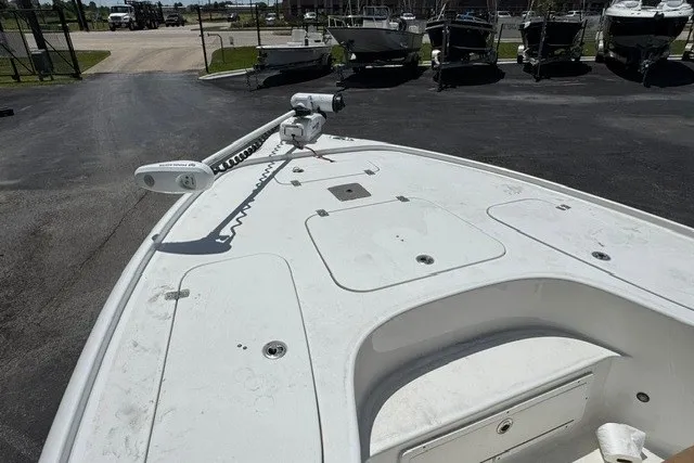 Slide: The Image of 2019 Sea Hunt BX22BR boat deck with trolling motor in a marina setting. - 19