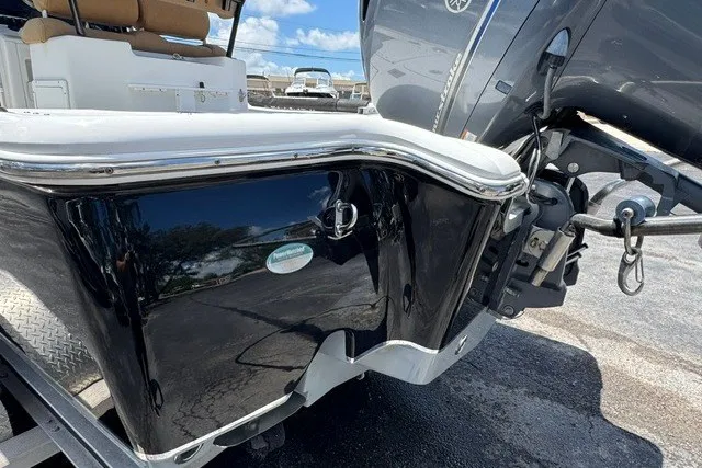 Slide: The Image of 2019 Sea Hunt BX22BR boat with sleek black exterior and powerful outboard motor. - 8