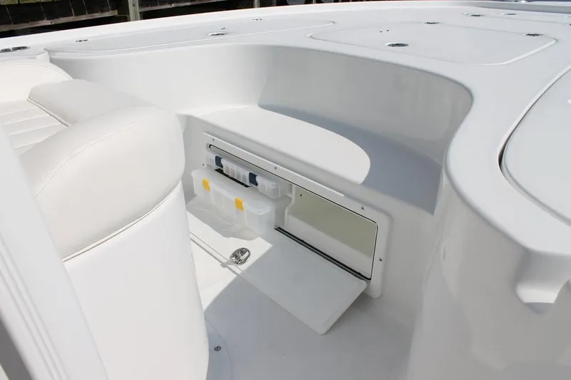 Slide: The Image of Manufacturer Provided Image: The image shows the cockpit of a 2019 Sea Hunt BX22BR boat with storage space. - 23
