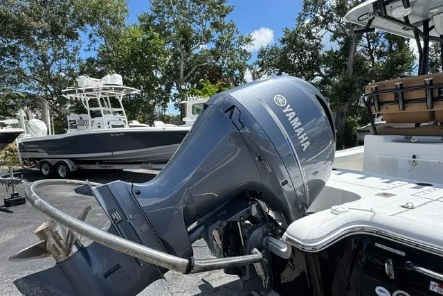 Slide: The Image of 2019 Sea Hunt BX22BR boat with Yamaha outboard motor, parked outdoors. - 6