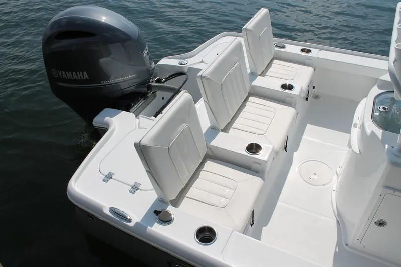 Slide: The Image of Manufacturer Provided Image: The image shows the stern of a 2019 Sea Hunt BX22BR boat with white seats and a Yamaha outboard motor. - 27