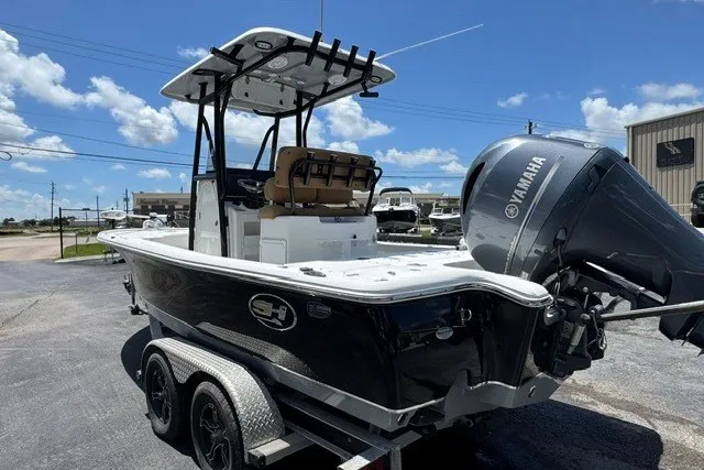 Slide: The Image of 2019 Sea Hunt BX22BR boat with Yamaha engine on a trailer, parked outdoors. - 9