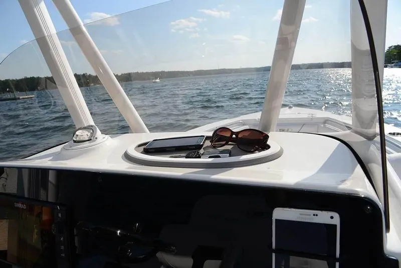 Slide: The Image of Manufacturer Provided Image: The image shows the cockpit of a 2019 Sea Hunt BX22BR boat on the water. - 25