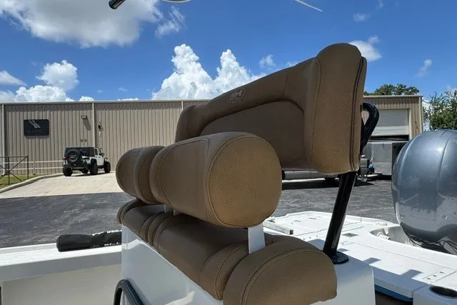 Slide: The Image of 2019 Sea Hunt BX22BR boat with tan seating, parked outdoors under a blue sky. - 15