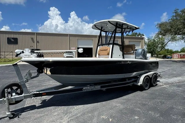 Slide: The Image of 2019 Sea Hunt BX22BR boat on trailer, parked outdoors under blue sky. - 12