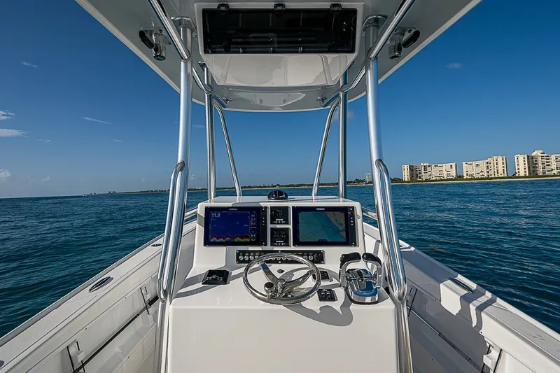 Slide: The Image of Cockpit view of 2019 Ocean Master 296 boat on open water, with navigation screens. - 10