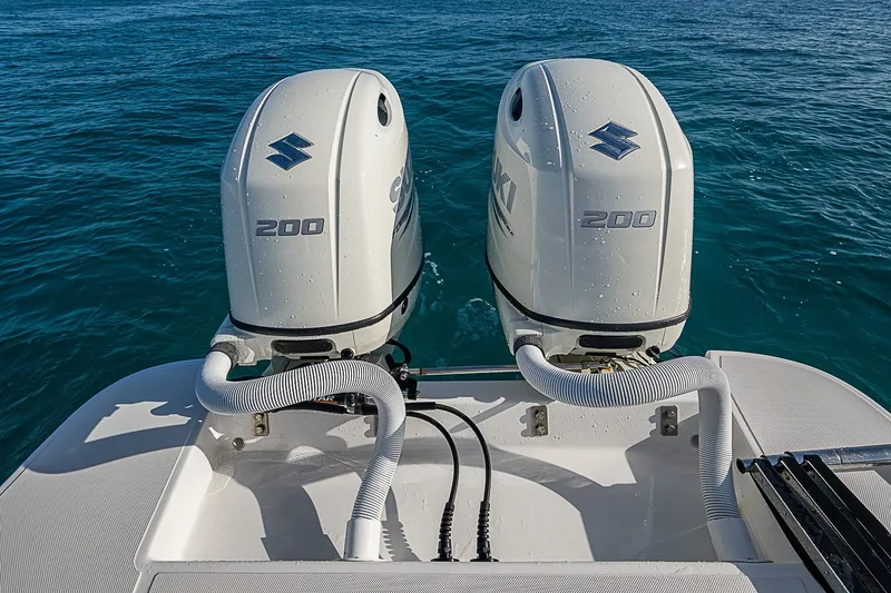 Slide: The Image of Twin Suzuki 200 outboard motors on a 2019 Ocean Master 296 boat in open water. - 19