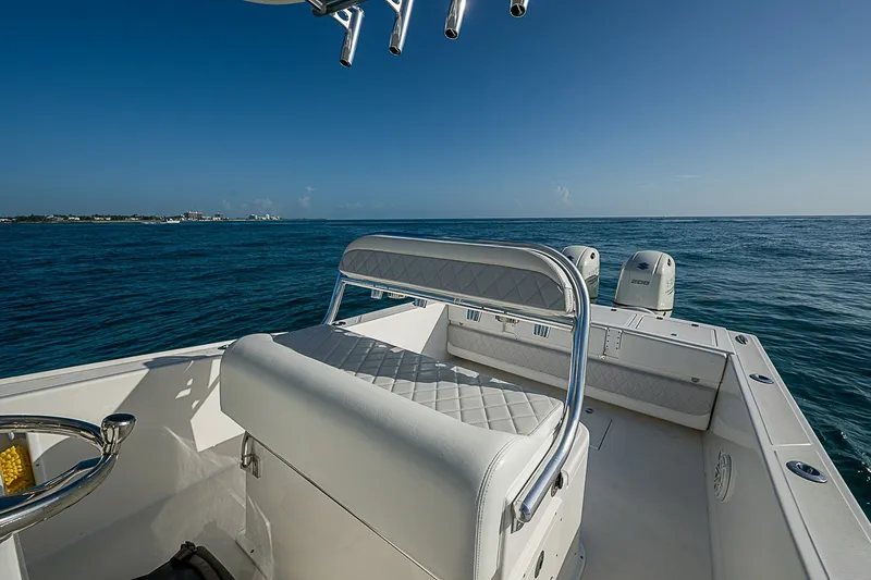 Slide: The Image of 2019 Ocean Master 296 boat on open sea, featuring dual engines and cushioned seating. - 12