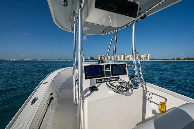 Slide: The Image of 2019 Ocean Master 296 boat helm with navigation screens on open water. - 11