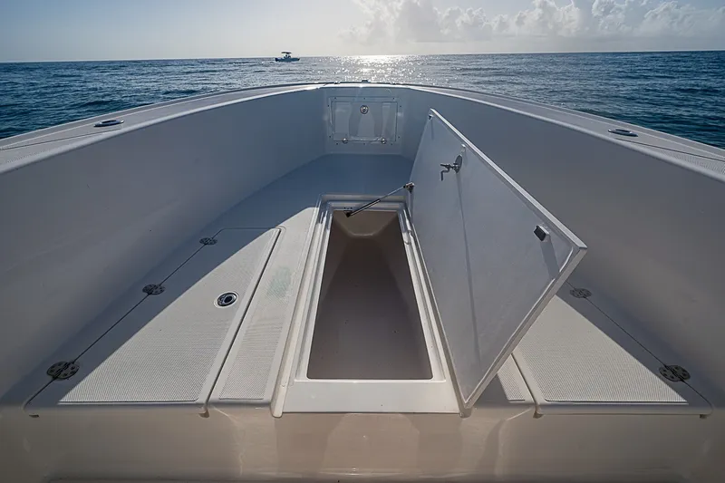 Slide: The Image of Open storage compartment on 2019 Ocean Master 296 boat, with ocean view in background. - 7
