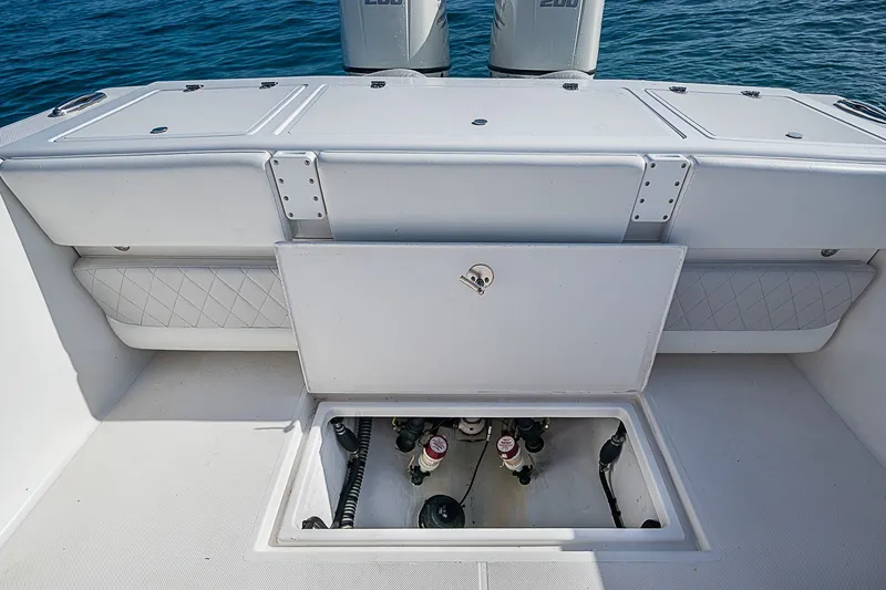 Slide: The Image of 2019 Ocean Master 296 boat deck with open hatch, revealing storage compartment. - 17